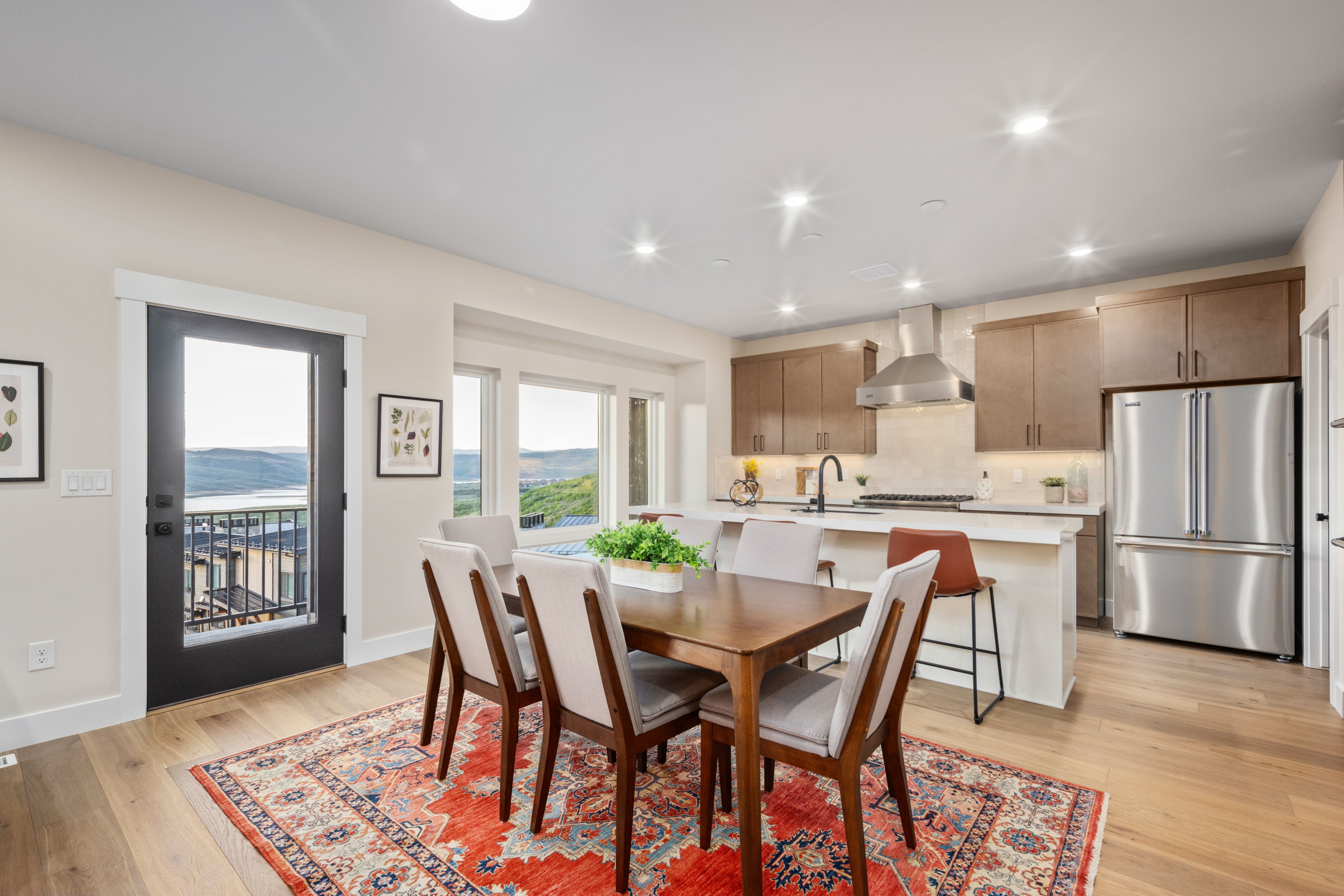 Open-concept dining and kitchen area with wood-finish flooring