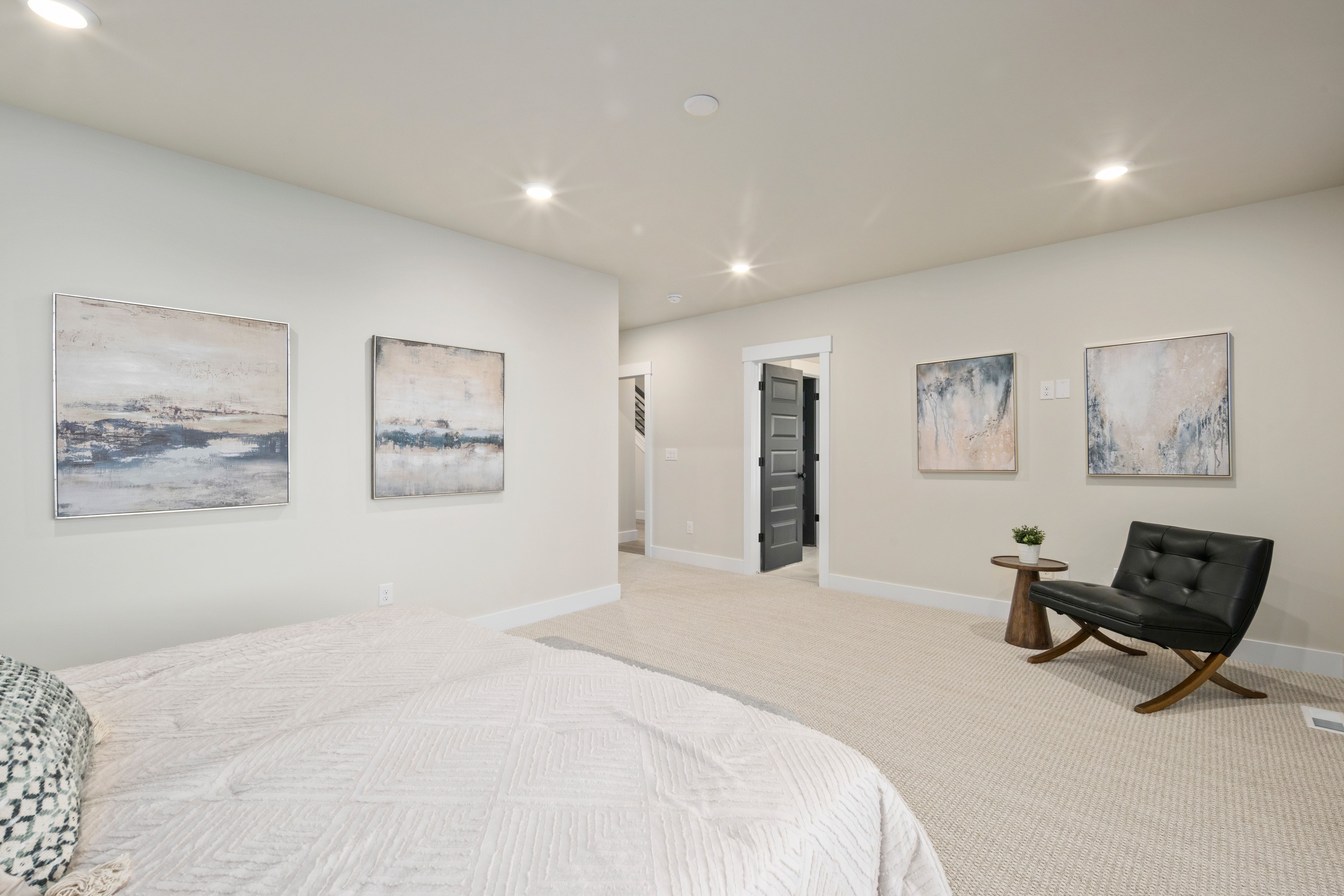 Spacious room featuring neutral carpeting, recessed lighting, light-toned walls, and white baseboards