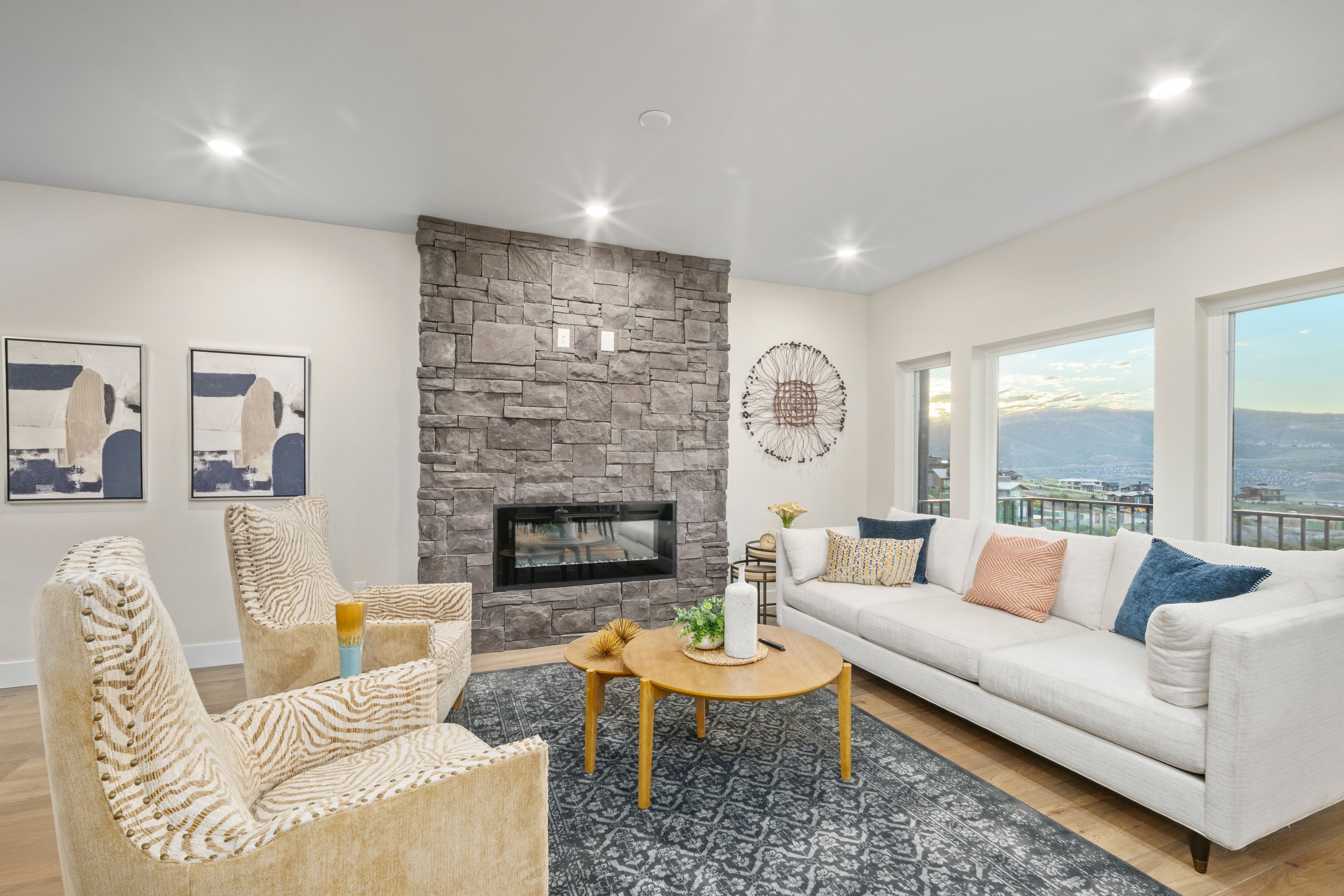 Living area featuring a floor-to-ceiling stone fireplace with an integrated linear firebox