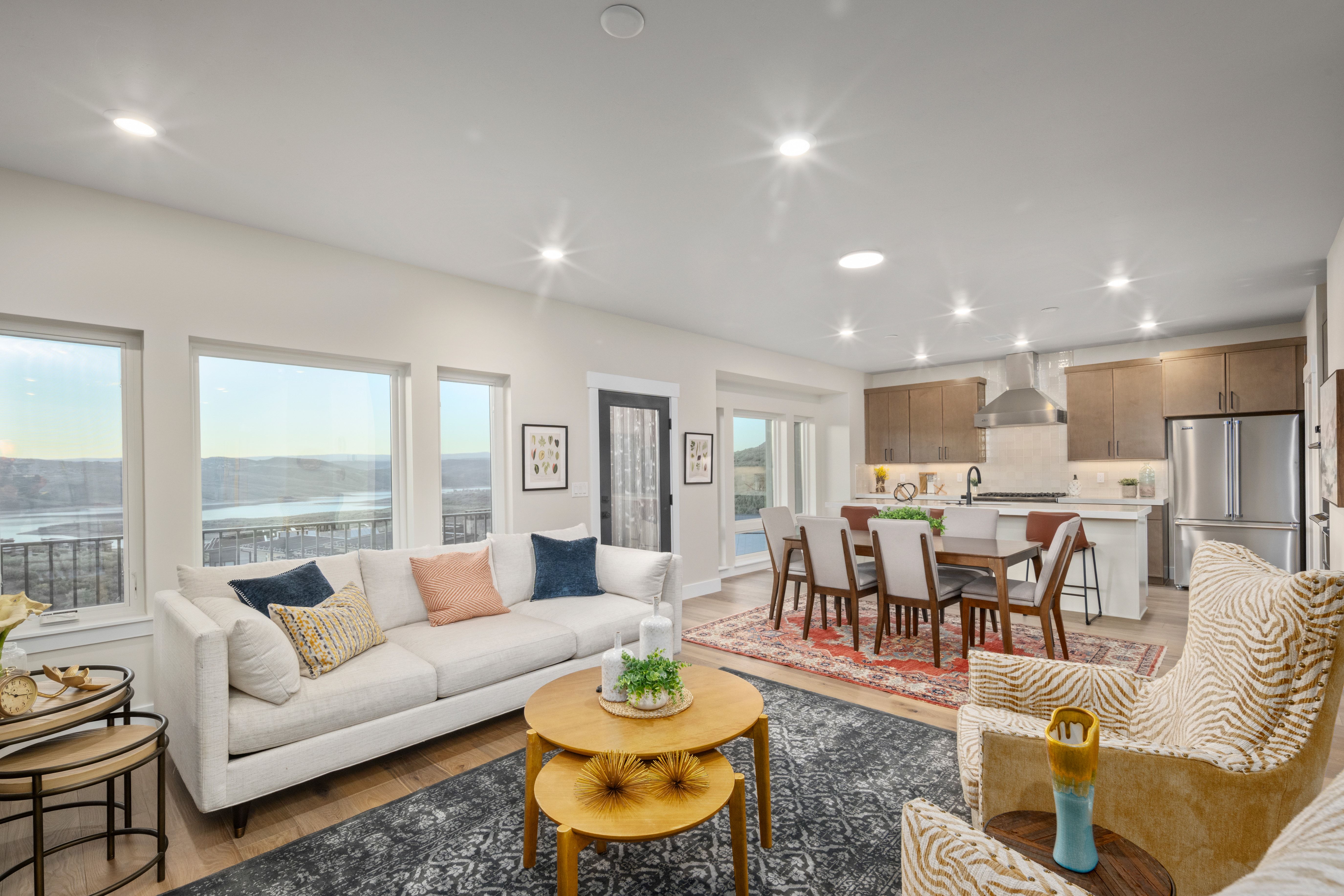 Open-concept living space featuring wood-finish flooring, recessed lighting, and expansive windows