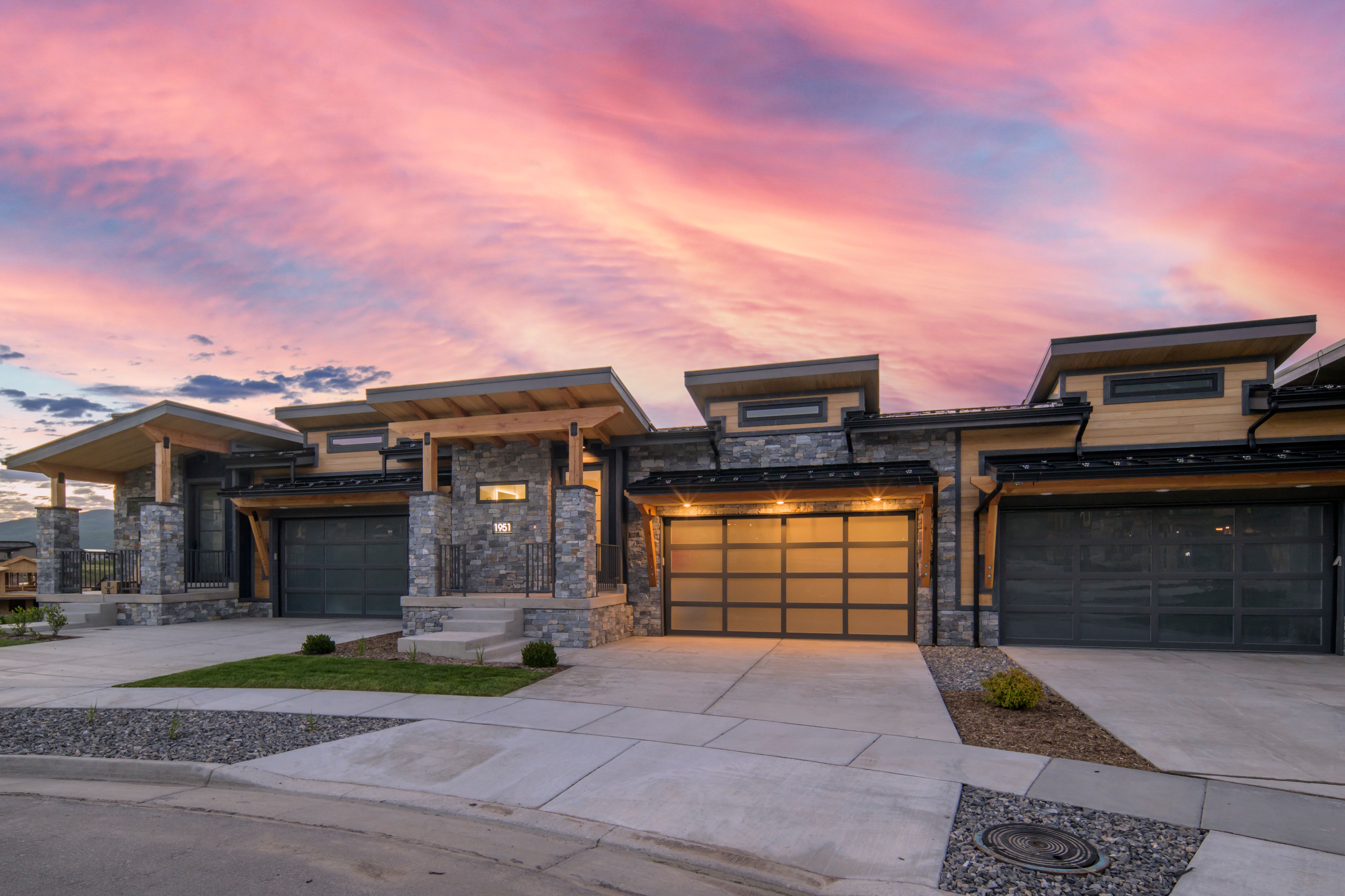 Contemporary townhome architecture featuring stone and wood siding