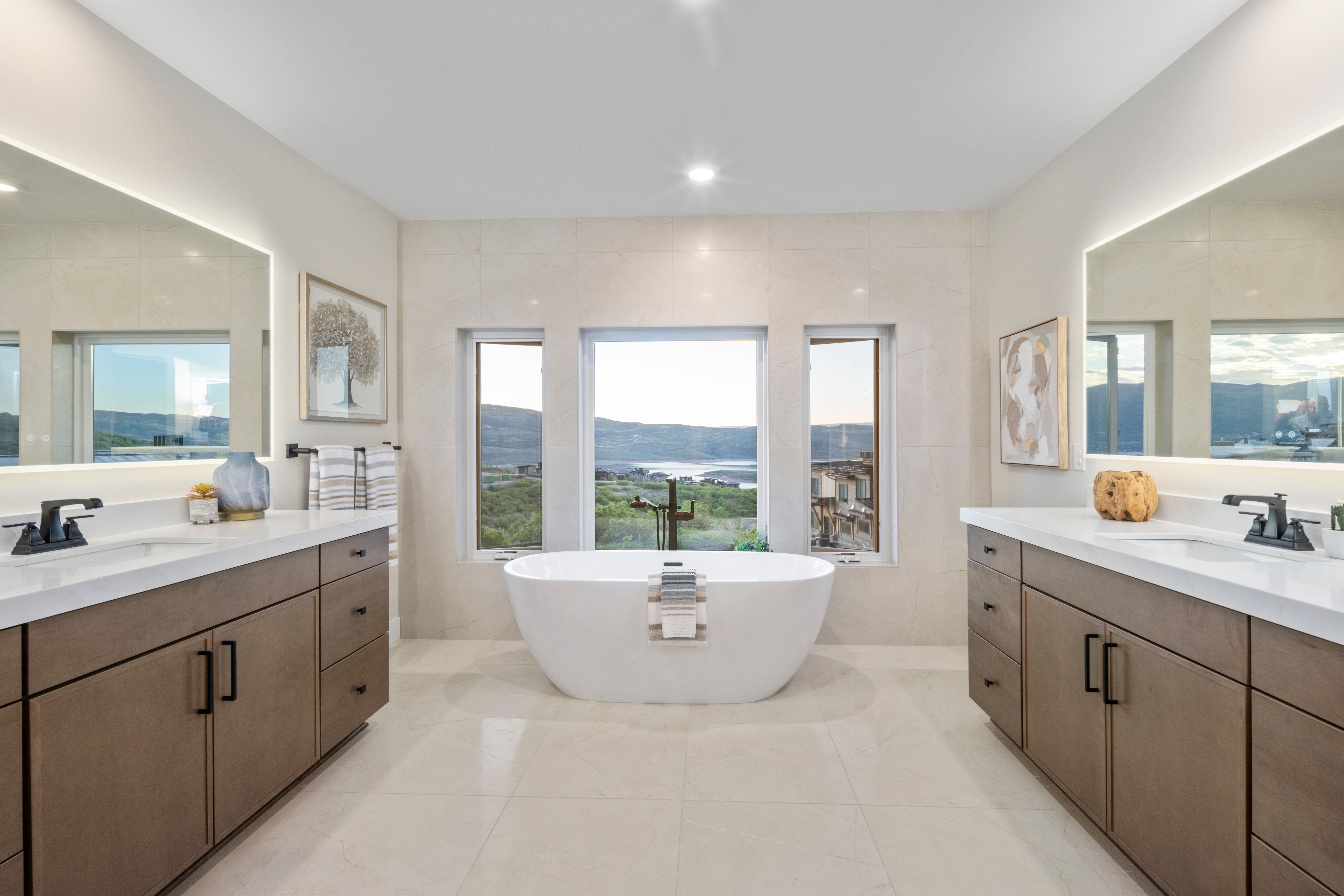 Freestanding soaking tub centered under three windows