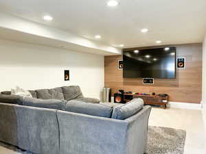 Theater room featuring recessed lighting, surround sound speakers, and an accent wall