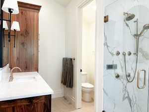 Full bathroom featuring 2 vanities and a custom shower