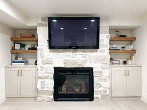 Detailed view of a stone fireplace and built-in cabinetry