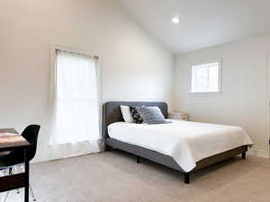 Bedroom with lofted ceiling and recessed lighting