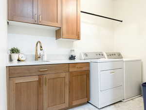 Laundry area featuring cabinet space and sink