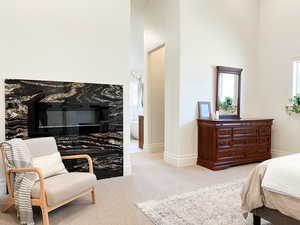 Bedroom featuring vaulted ceilings and a fireplace