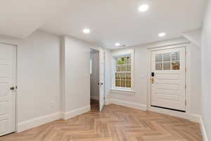 Entryway featuring parquet flooring and recessed lighting