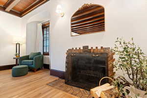Detailed view of wood finished floors and a wood ceiling with exposed beams