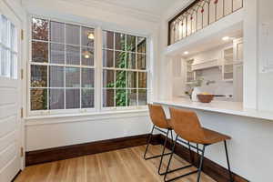 Dining room featuring light wood-style floors and ornamental molding