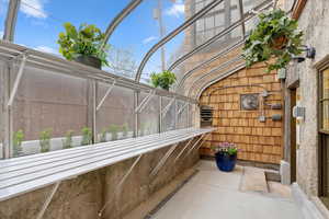 View of patio with a sunroom