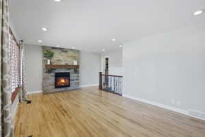Living area featuring a stone-faced fireplace with a wood mantel