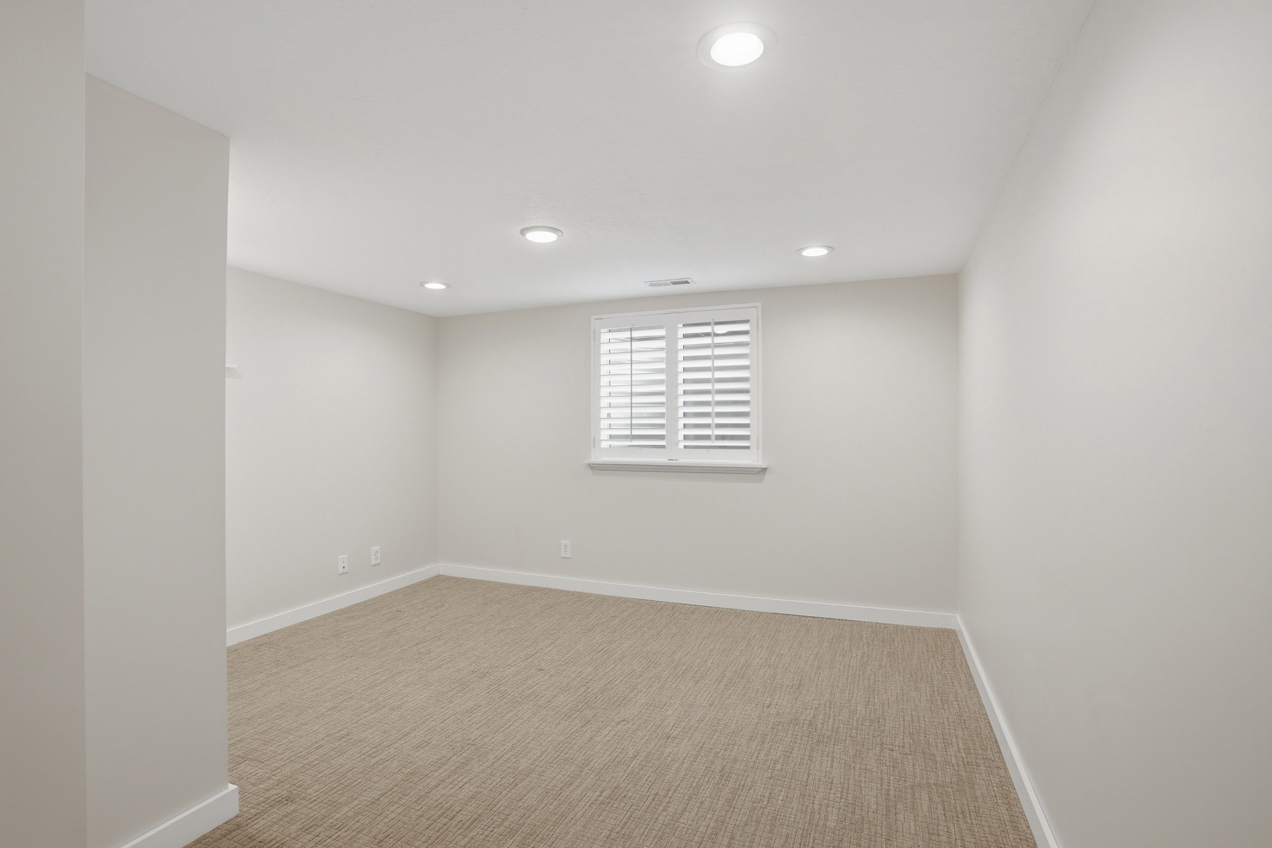 Carpeted bedroom with recessed lighting
