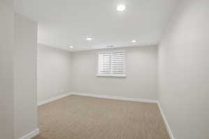 Carpeted bedroom with recessed lighting