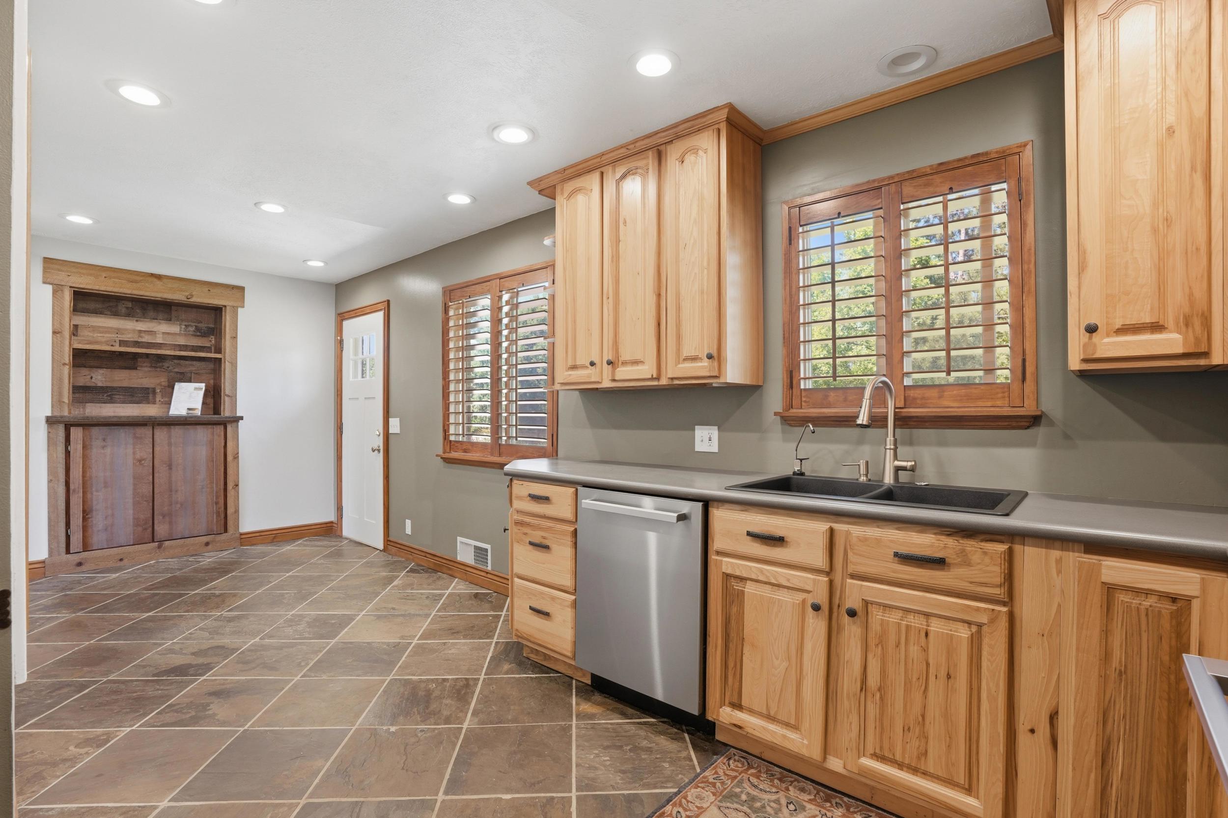 Kitchen area featuring light wood cabinetry and diamond-patterned floor tiling