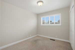 Unfurnished bedroom featuring a closet and carpet floors