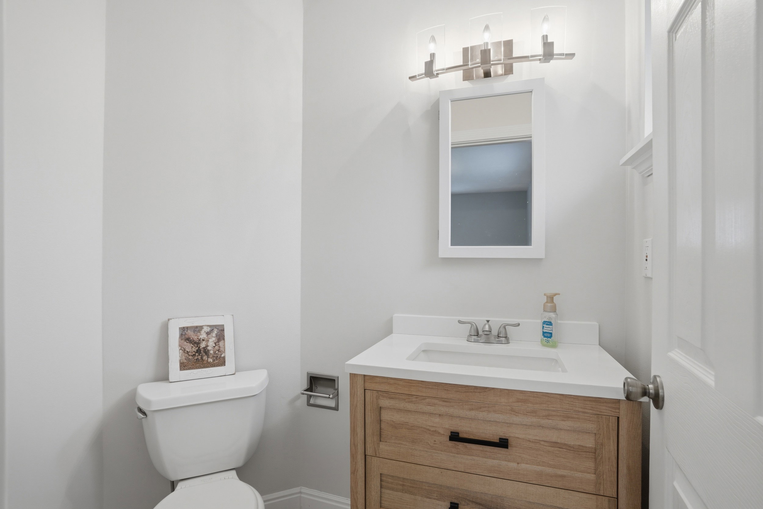 Half bath with vanity and toilet
