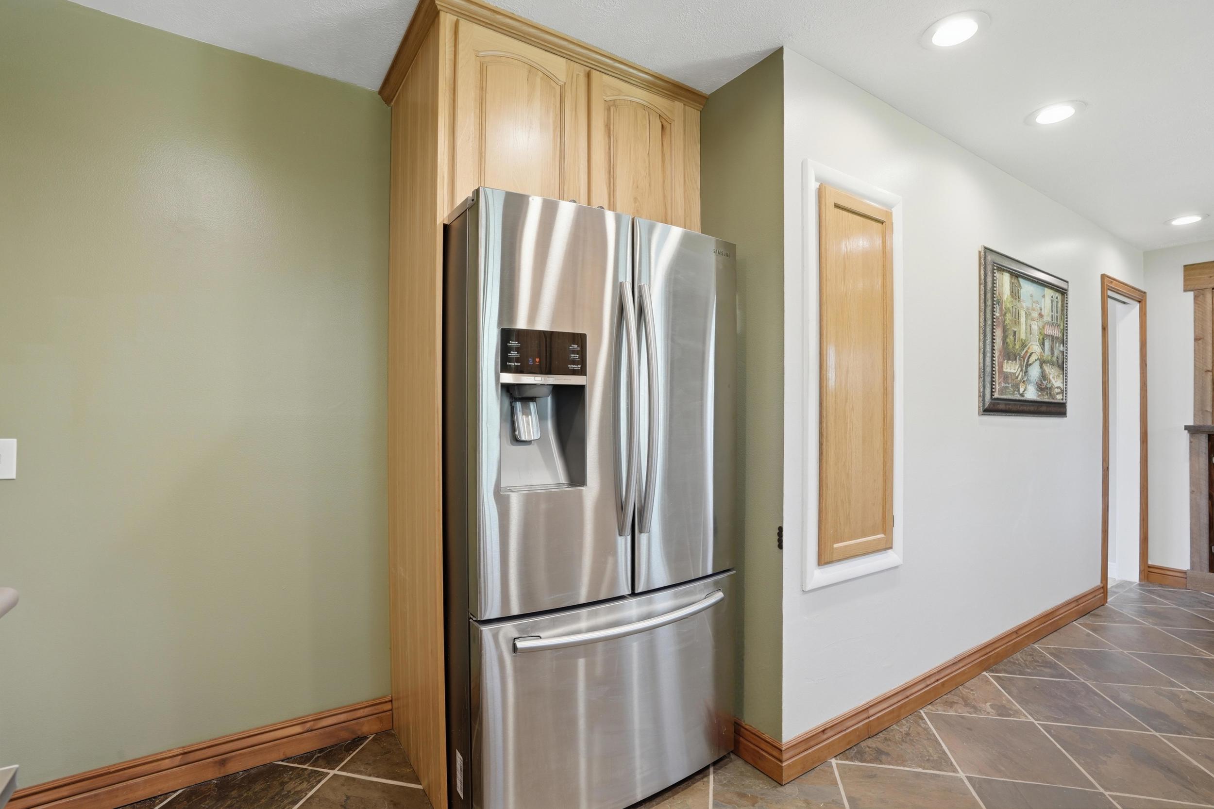 Recessed refrigerator with built-in cabinetry surround