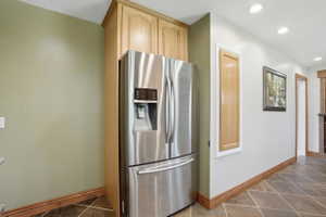 Recessed refrigerator with built-in cabinetry surround