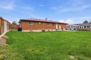 Rear view of property featuring a fenced backyard, a patio, and brick siding