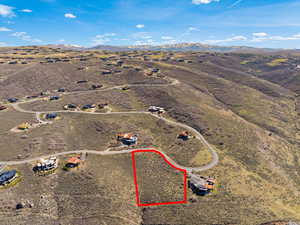 Aerial view of sparsely populated area with a mountainous background and a desert landscape