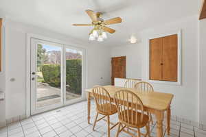 Dining area with ceiling fan and light tile patterned flooring