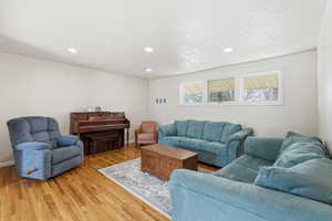 Living area featuring light wood-type flooring and recessed lighting