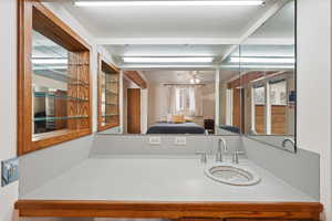 Ensuite bathroom with vanity and a ceiling fan