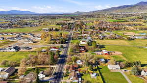 View of property location featuring mountains and nearby suburban area