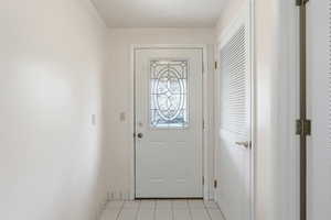 Doorway featuring tile patterned floors