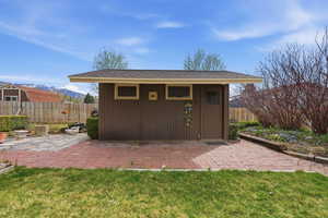 View of outdoor structure featuring a fenced backyard and a mountain view