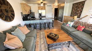 Living area with wood finished floors and ceiling fan