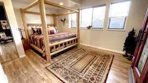 Bedroom with light wood-style floors and baseboards