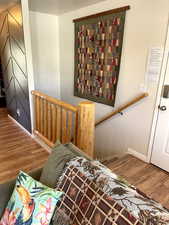 Stairs featuring wood finished floors and baseboards