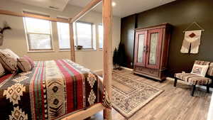 Bedroom featuring light wood-style floors and baseboards
