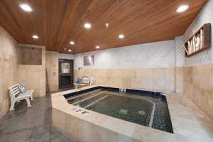 Kitchen featuring tile walls, recessed lighting, wood ceiling, light wood finish cabinetry, and dark tile patterned flooring