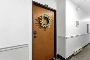 Entrance to property with a baseboard radiator