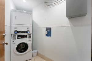 Laundry room with stacked washer and clothes dryer