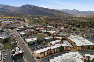 Aerial view of property and surrounding area featuring mountains