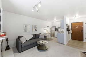 Living area featuring baseboards and track lighting
