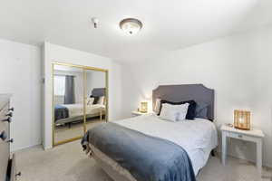 Bedroom with a closet and light carpet
