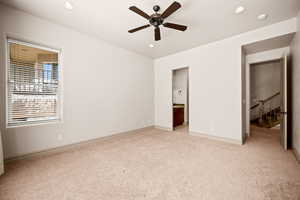 Unfurnished bedroom with connected bathroom, light carpet, recessed lighting, and ceiling fan