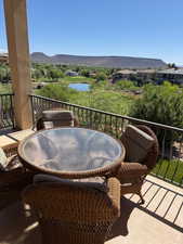 Balcony featuring a water and mountain view