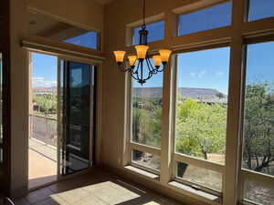 Doorway featuring a chandelier and a mountain view