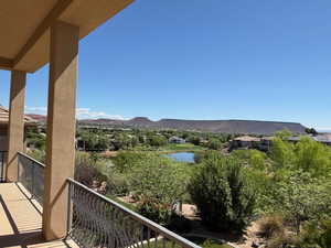 Balcony featuring a water and mountain view
