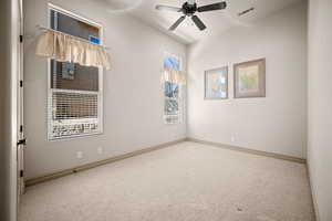 Empty room featuring a ceiling fan and light colored carpet