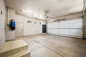 Garage with a central vacuum unit and a garage door opener