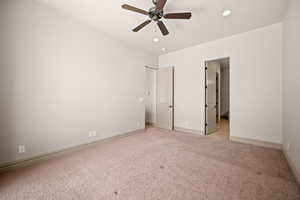 Unfurnished bedroom featuring light carpet, ceiling fan, and recessed lighting