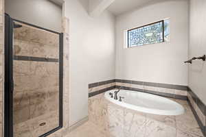 Full bathroom with a garden tub, a stall shower, and tile patterned flooring